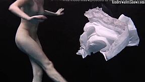 aqua girl andrejka strips underwater while swimming in the pool