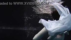 aqua girl andrejka strips underwater while swimming in the pool