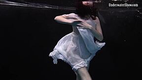 aqua girl andrejka strips underwater while swimming in the pool
