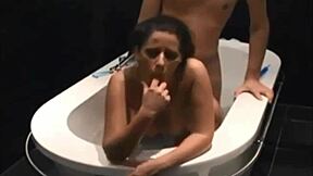 Dark haired vixen blows and fucks in bathtub.