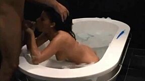 Dark haired vixen blows and fucks in bathtub.