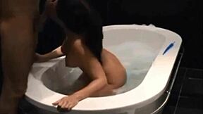 Dark haired vixen blows and fucks in bathtub.