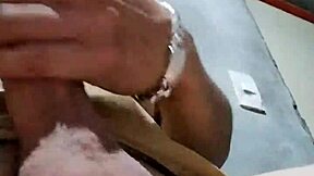 I'm masturbating in the bathroom at my job, feeling horny and reaching orgasm with my cock