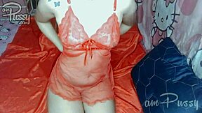 Amateur girl in see-through lingerie indulges in solo shaved pussy play at home