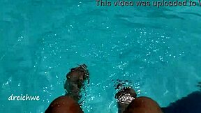 Young Amateur Plays with Feet in Pool