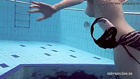 bushy round-ass girls strip down and swim underwater in bikinis.