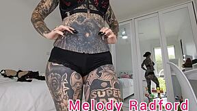 Melody Radford's black and red lingerie try on haul in closeup with petite goth tattoo details.