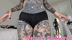 Melody Radford's black and red lingerie try on haul in closeup with petite goth tattoo details.