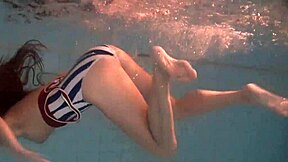 Beautiful teen Natalia swims naked in pool!