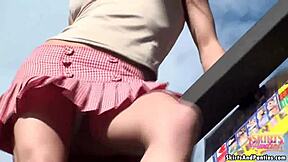 A naughty teen babes shows off her panties while doing house chores