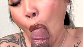 In a close up, an asian woman interacts intimately with a big black cock in an interracial scene