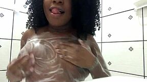 ebony teen reaches orgasm in the shower, playing with her ass and cum