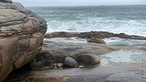 african latina teen takes photos on the beach