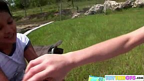 Brookeskye and Asian babe lick dildo outdoors. Such a hot scene!