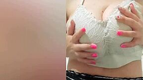 Pretty student with brown hair teases her big tits after school.