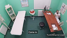 Doctor interacts with petite patient in a fake hospital environment