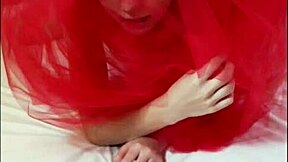 odette cavorts on her red bed, teasing her small tits and pussy