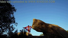 Watch her big tits bounce as she plays on the rock?