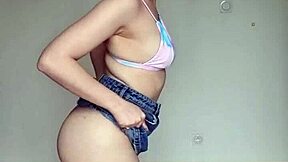 Hey, check out this skinny brunette with pierced nipples in a skirt and swim bra!