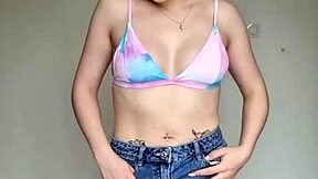 Hey, check out this skinny brunette with pierced nipples in a skirt and swim bra!