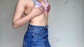 Hey, check out this skinny brunette with pierced nipples in a skirt and swim bra!