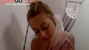 Amazing blonde with huge boobs bathing in shower on webcam.