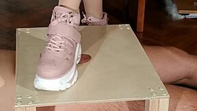 Goth domina in pink boots humiliates slave with cock stomping