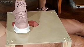 Goth domina in pink boots humiliates slave with cock stomping