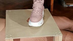 Goth domina in pink boots humiliates slave with cock stomping