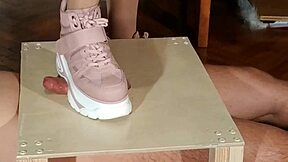 Goth domina in pink boots humiliates slave with cock stomping