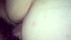 A young woman enjoys intimate moments in a private setting