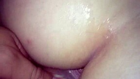 A young woman enjoys intimate moments in a private setting