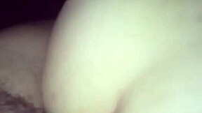 A young woman enjoys intimate moments in a private setting