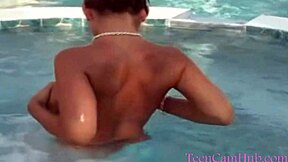 Teen model teases with big tits in bikini by pool