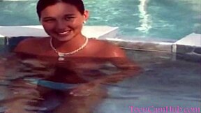 Teen model teases with big tits in bikini by pool