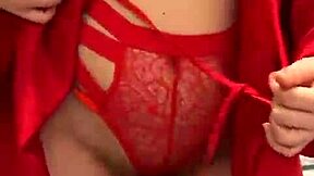 brunette in red lingerie teases with her big assets.
