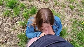 Cute chubby teen sucks cock with drool in open field