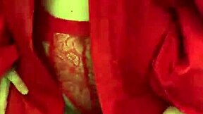 brunette in red lingerie teases with her big assets.