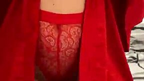 brunette in red lingerie teases with her big assets.