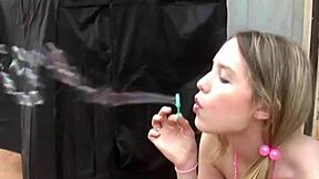 Kitty Karsen plays with bubbles nude, showing her tits and fingering pussy.