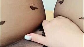 Teen achieves orgasm through pantyhose masturbation outdoors