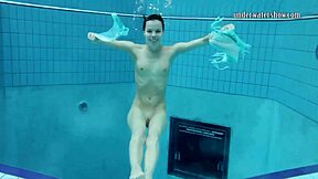 Gazel Podvodkova strips naked underwater at public pool.