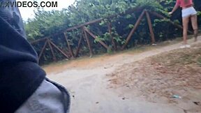 Teen indulges in solo hentai play outdoors, stroking herself in public forest near the street.