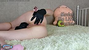 Petite 18+ student in fetish latex gloves pisses while masturbating her big clitoris with stepsister butt plug in ass.