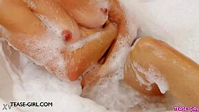 Petite Brunette Model Enjoys Relaxing Bath On Sofa