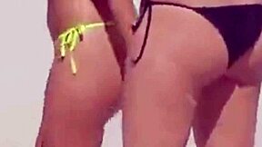 young girl struts a tiny bikini on the beach while boyfriend’s relatives watch.