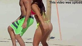 young girl struts a tiny bikini on the beach while boyfriend’s relatives watch.