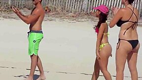 young girl struts a tiny bikini on the beach while boyfriend’s relatives watch.