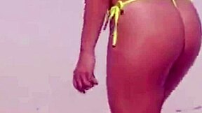 young girl struts a tiny bikini on the beach while boyfriend’s relatives watch.