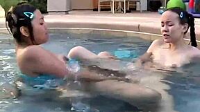 Tiny tabby and lesbian friend swim and lick at pool